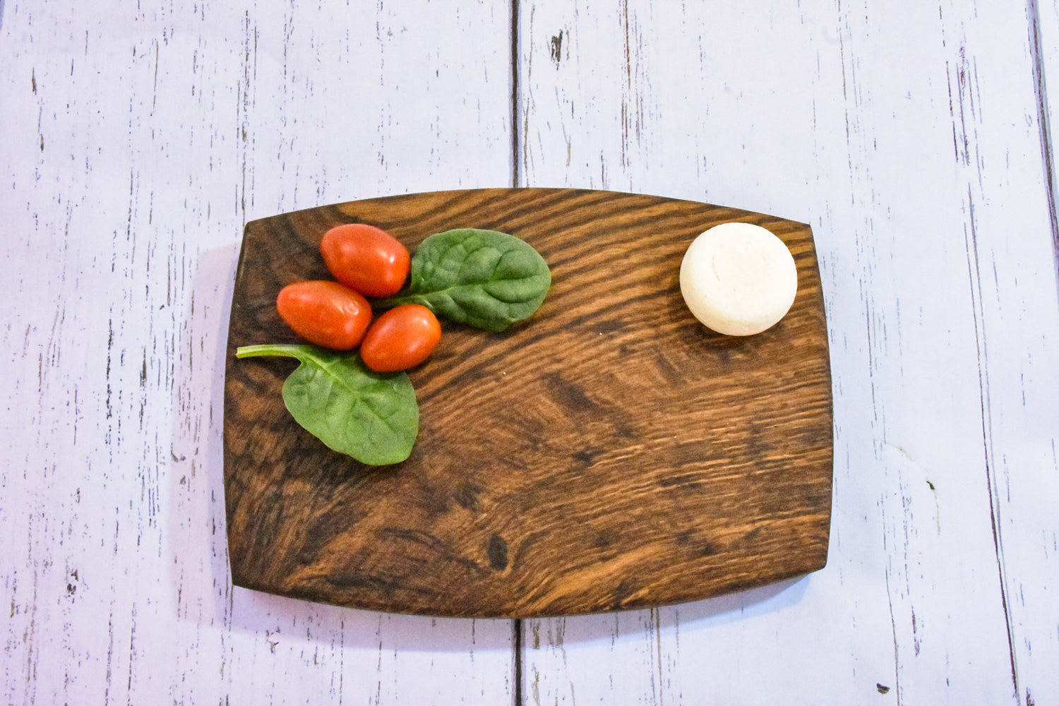 a small cheese board with tomatoes