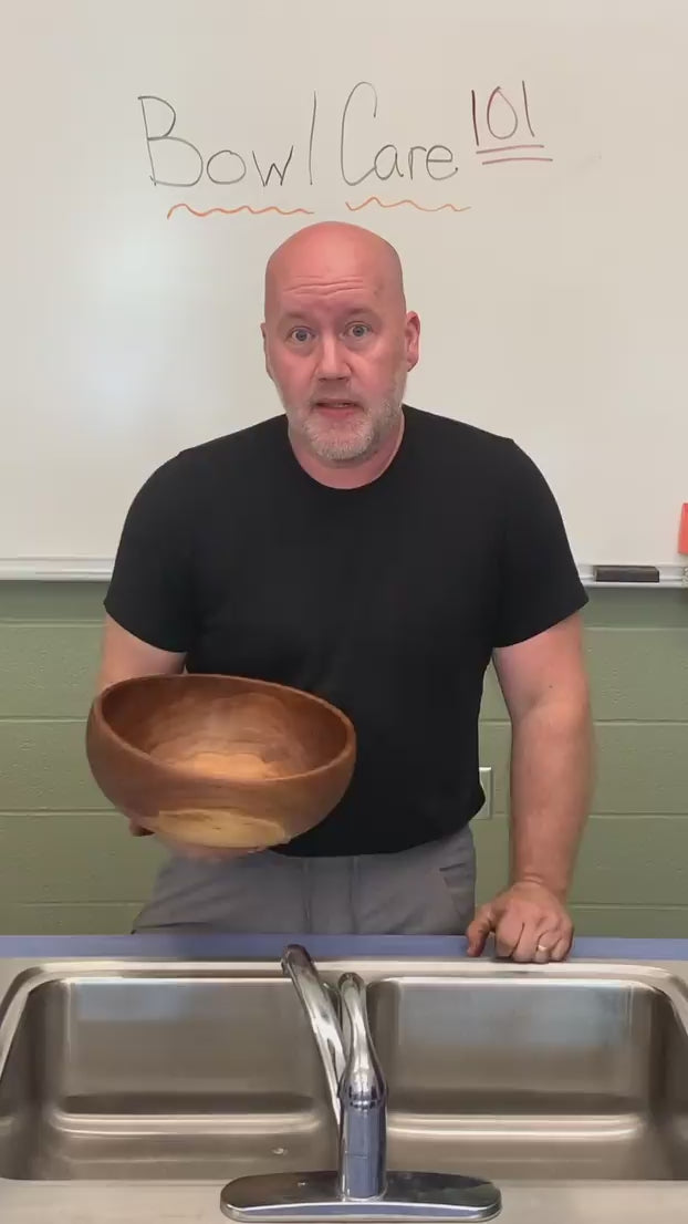 Load video: a video of a man showing how to clean a wood bowl with water, gentle soap, and a towel